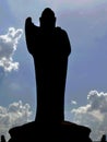 Buddha statue silhouette with clouds