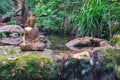 Buddha statue sitting in a mountain river meditating on a waterfall Royalty Free Stock Photo