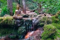 Buddha statue sitting in a mountain river meditating on a waterfall Royalty Free Stock Photo