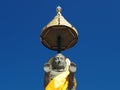 Buddha statue soars into blue sky Royalty Free Stock Photo