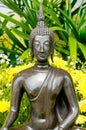 Buddha statue with yellow flower Royalty Free Stock Photo