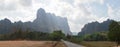 Buddha Statues in a green field at the base of Mount Zwegabin near Hpa-An, Myanmar.