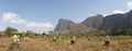 Buddha Statues in a green field at the base of Mount Zwegabin near Hpa-An, Myanmar.