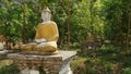 Buddha Statues in a green field at the base of Mount Zwegabin near Hpa-An, Myanmar.