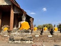 Buddha statues seated outside the main pagoda of Wat Yai Chaimongkol, Ayutthaya Royalty Free Stock Photo