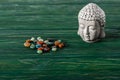 Buddha statuette and colorful semiprecious stones