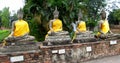 Buddha stone statues dressed in yellow in Ayutthaya Thailand Royalty Free Stock Photo