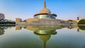 Buddha stupa with water reflection and bright blue sky at morning