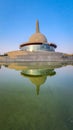 Buddha stupa with water reflection and bright blue sky at morning