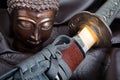 Buddha versus sword Royalty Free Stock Photo