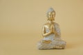 Buddhism background.Buddha golden statue on beige background.Beautiful meditation and harmony background in golden