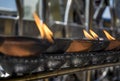 Buddhist altar with burning wooden cups