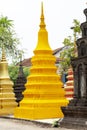 Buddhist architecture in Wat Damnak pagoda, Siem Reap, Cambodia. Yellow funeral stupa with relief.