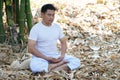 Buddhist Asian man in white custom doing meditation Royalty Free Stock Photo