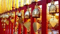 Buddhist brass bell hanging on red fence Royalty Free Stock Photo