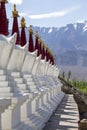 Buddhist chortens, white stupa and Himalayas mountains in the background near Shey Palace in Ladakh, India Royalty Free Stock Photo
