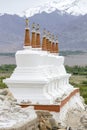 Buddhist chortens, white stupa and Himalayas mountains in the background near Shey Palace in Ladakh, India Royalty Free Stock Photo