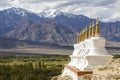 Buddhist chortens, white stupa and Himalayas mountains in the background near Shey Palace in Ladakh, India Royalty Free Stock Photo