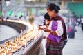 Buddhist devotees lighting candles