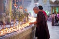 Buddhist devotees lighting candles at the full moo