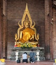 Buddhist faithful pray inside Wat Yai Chai Mongkhon, a Buddhist temple of archaeological park