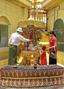 Buddhist family bathing Buddha statu