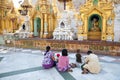 Buddhist family devotees prays to statue of Buddha