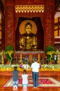 A Buddhist family is praying for peace in front of the main hall temple