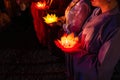 Buddhist hold lanterns and garlands praying at night on Vesak day for celebrating Buddha`s birthday in Eastern culture