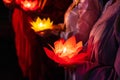 Buddhist hold lanterns and garlands praying at night on Vesak day for celebrating Buddha`s birthday in Eastern culture