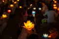 Buddhist hold lanterns and garlands praying at night on Vesak day for celebrating Buddha`s birthday in Eastern culture