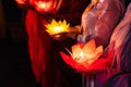 Buddhist hold lanterns and garlands praying at night on Vesak day for celebrating Buddha`s birthday in Eastern culture