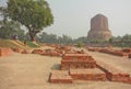 Buddhist landmark, ruined temple walls and sacred Dhamekh Stupa in indian Sarnath. Royalty Free Stock Photo