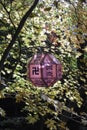 Buddhist lantern, day hanging outdoor against autumn leaves