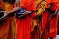 Buddhist Lent concept using : Monks in robes collecting alms