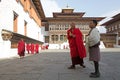 Buddhist monk and bhutanese man at the Trashi Chhoe Dzong, Thimphu, Bhutan Royalty Free Stock Photo