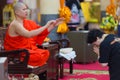 Buddhist monk blessing woman Royalty Free Stock Photo