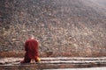 Buddhist monk at Buddha's cremation stupa in a foggy morning, Kushinagar, India