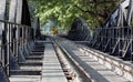 Buddhist Monk Crossing Bridge On the River Kwai in Kanchanaburi, Thailand