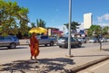 Buddhist monk crossing road of Siam Reap with sun umbrella