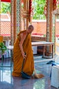 Buddhist monk doing some cleaning at buddhist temple from Damnoen Saduak Floating Market Royalty Free Stock Photo