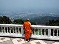 Buddhist monk enjoying the spectacular views from Wat Doi Suthep temple in Chiang Mai, Thailand