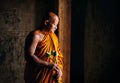 Buddhist monk hold lotus flower and standing Royalty Free Stock Photo