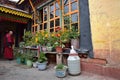 LHASA, TIBET AUTONOMOUS REGION, CHINA - CIRCA OCTOBER 2019: A Buddhist monk inside a Buddhist monastery Ramoche Temple. Royalty Free Stock Photo