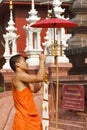 Buddhist monk lace the traditional flags on pole