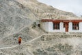 Buddhist monk Lama walking on the walk way of the mountain to the temple in winter at Ladakh, India Royalty Free Stock Photo