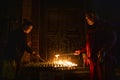 Buddhist monk lights a candle