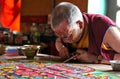 Buddhist monk making sand mandala