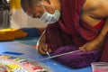 Buddhist monk making sand mandala