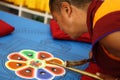 Buddhist monk making sand mandala.